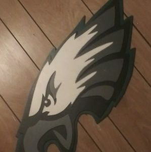 A EAGLES WOODEN PICTURE THAT HANGS ON THE WALL.